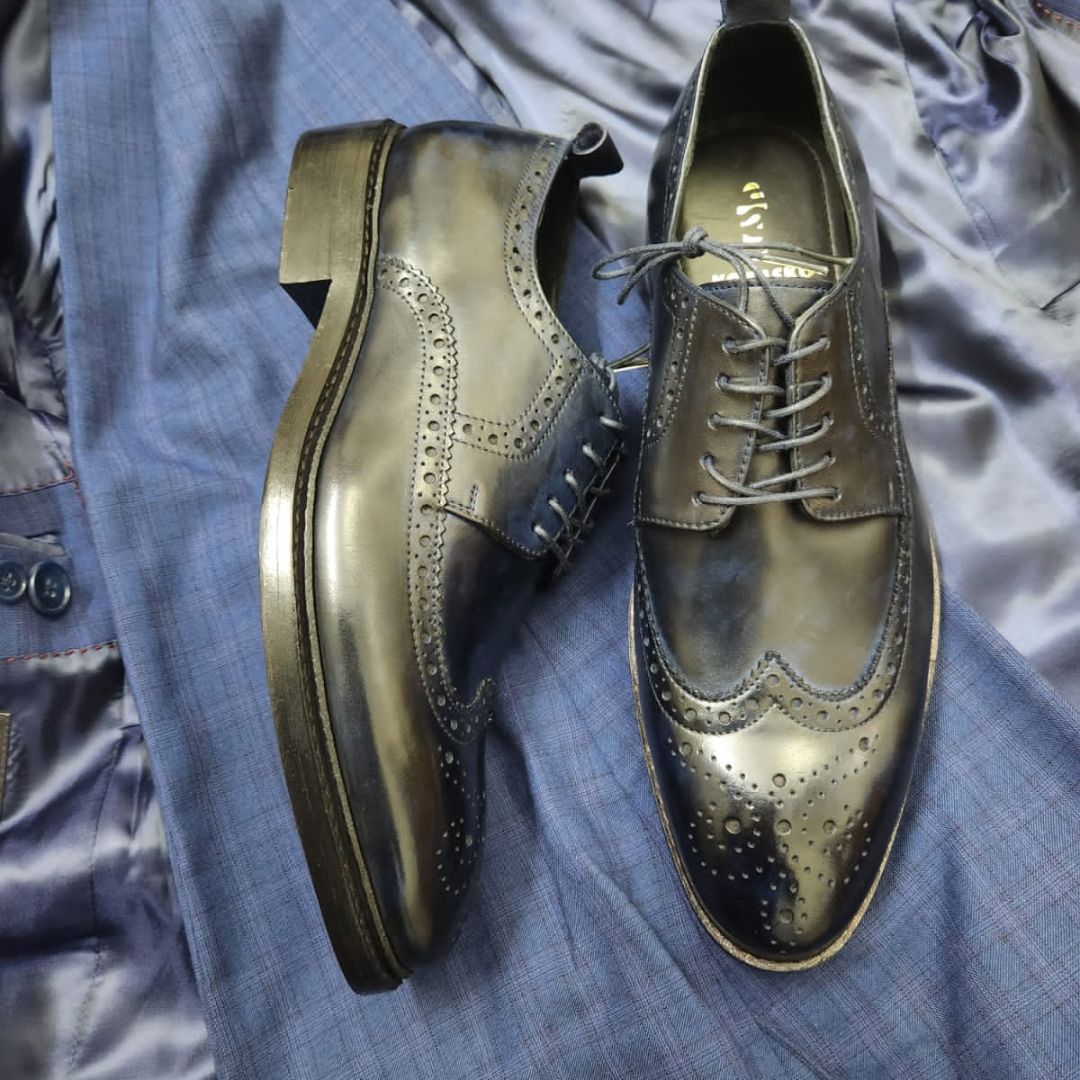 Goodyear welted wingtip navy leather derby shoe with medallion